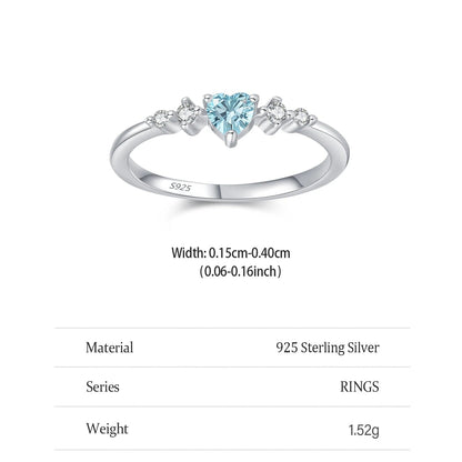 Silver ring with a heart-shaped blue gemstone on a white background
