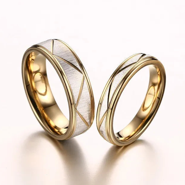Two gold wedding rings with a textured design on a white background