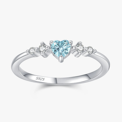 sterling silver womens promise ring with a heart-shaped sky blue gemstone