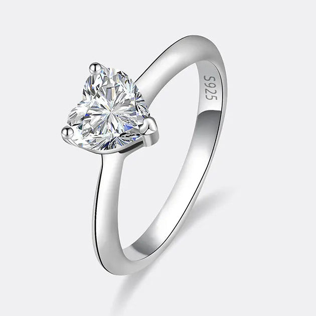 Silver ring with a heart-shaped diamond on a white background