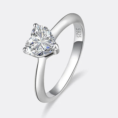Silver ring with a heart-shaped diamond on a white background