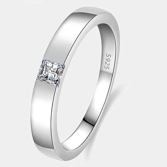 Silver unisex ring with a diamond on a white background